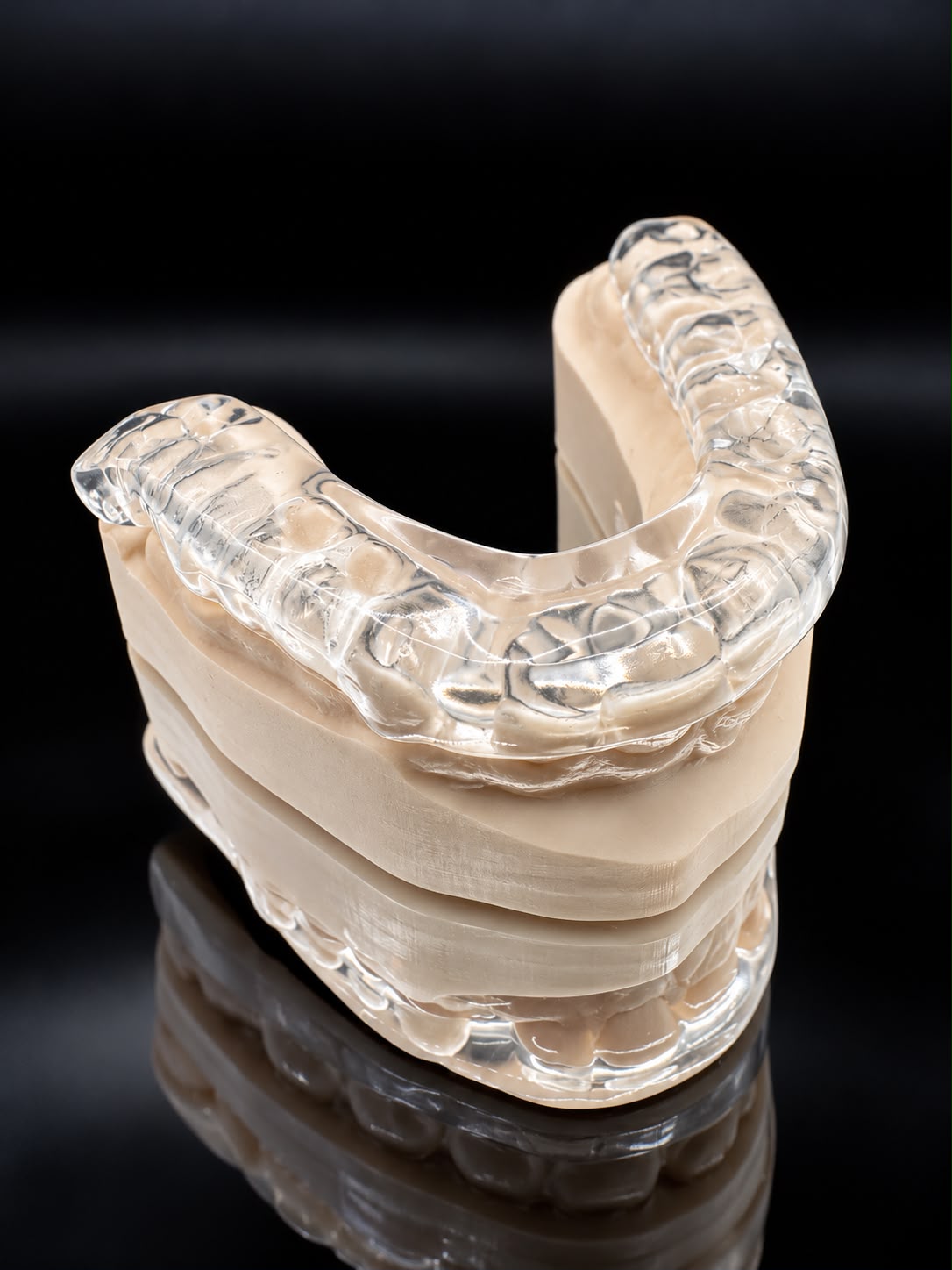 Clear Mini FM sleep appliance viewed at an angle on dental models